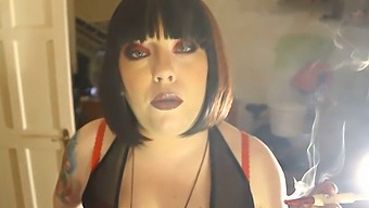 Domme Tina Smokes A Cigarette In A Holder While Dominating Submissive