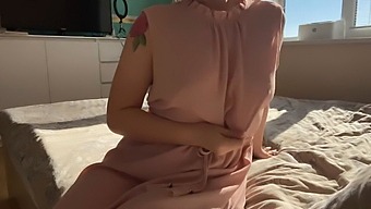 A Woman In A Pink Dress Indulges In Self-Pleasure